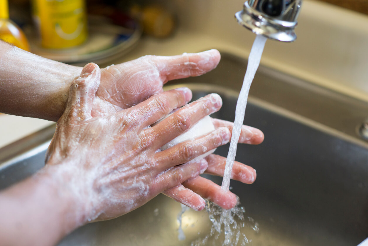 Closeup of an anonymous person's hands washing up because of OCD