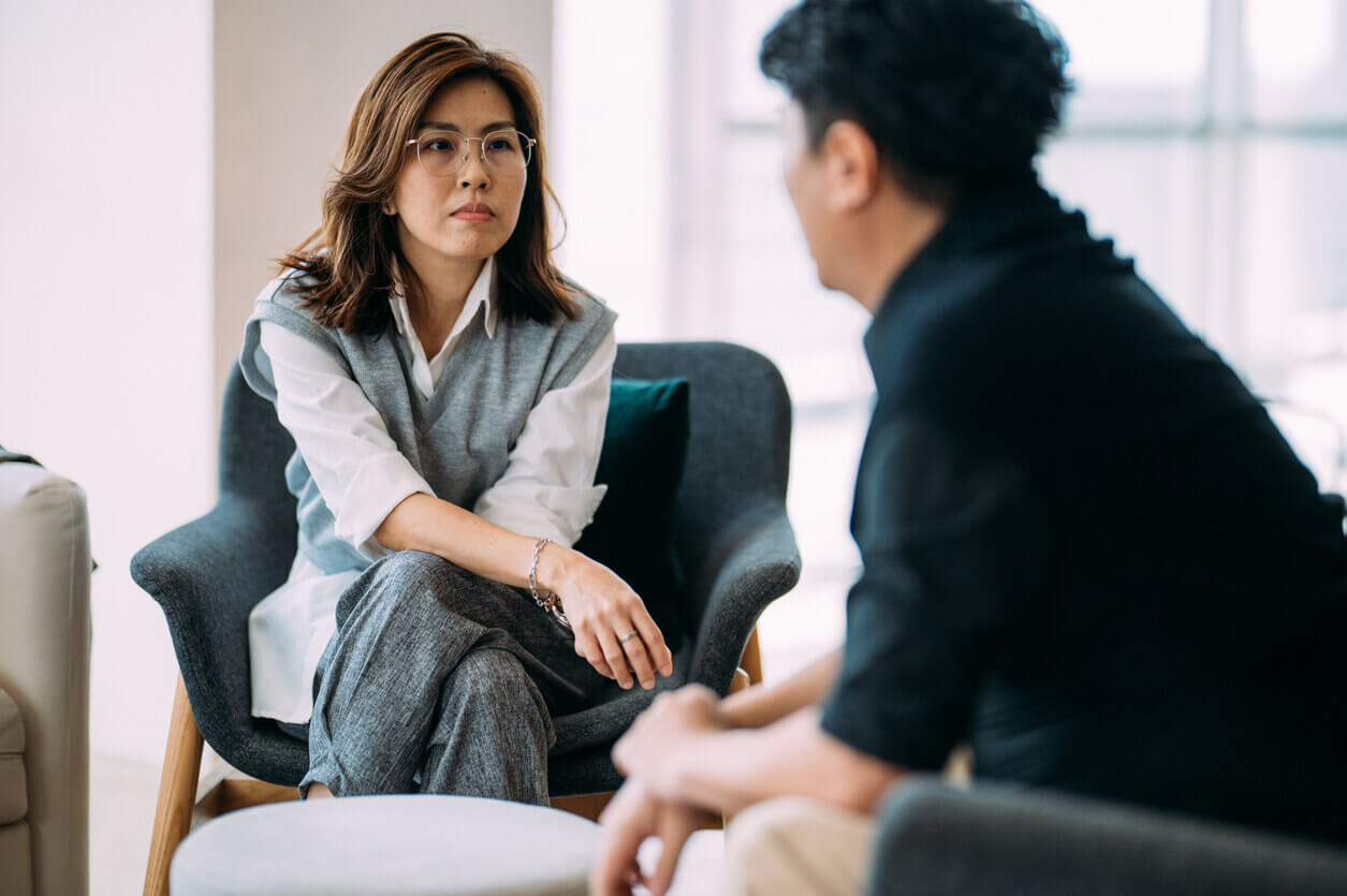 Psychotherapy session between an Asian Female Psychologist and a Mature Man