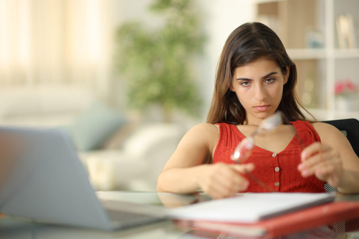 An adult with ADHD who becomes easily distracted is now playing with a pair of eyeglasses.