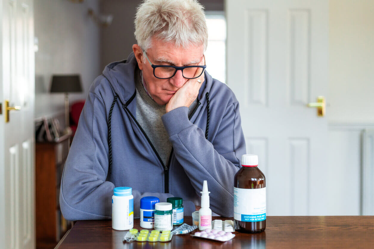 Senior man with OCD looking at his medication.