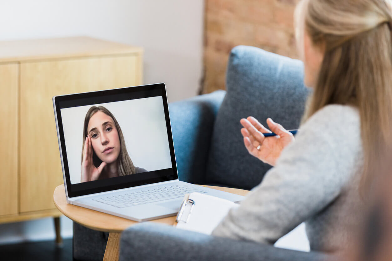 Telehealth illustration showing a female therapist meets with a patient with anxiety disorder via video conferencing.